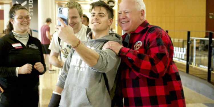 Minnesota Gov. Tim Walz has his photo taken with young fans.