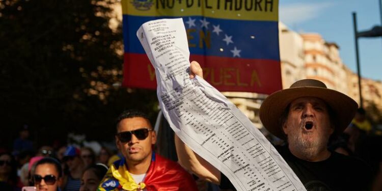 A protester chants slogans while holding the electoral records during a demonstration as Venezuelan citizens have gathered in the streets of Pamplona, to raise their voices against the electoral fraud that occurred in the elections held on July 28 in Venezuela.