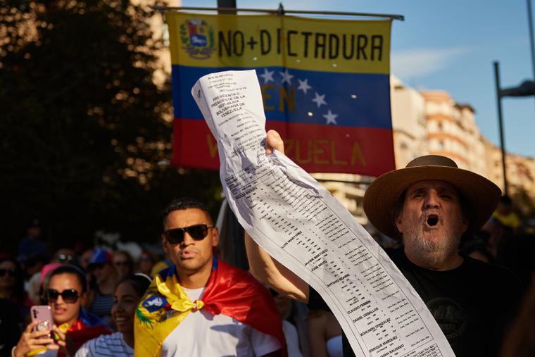 A protester chants slogans while holding the electoral records during a demonstration as Venezuelan citizens have gathered in the streets of Pamplona, to raise their voices against the electoral fraud that occurred in the elections held on July 28 in Venezuela.