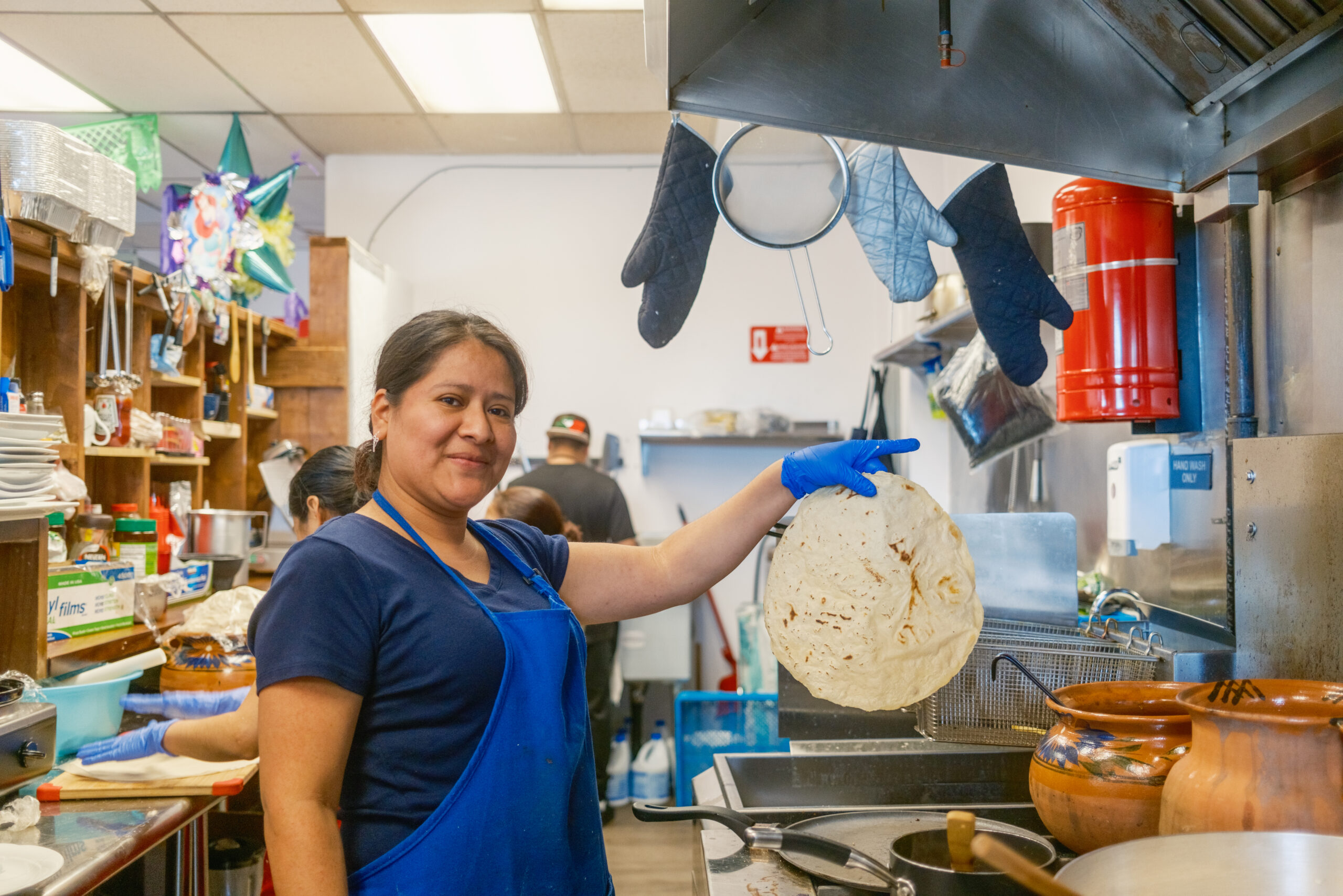 a person holds up a tortilla