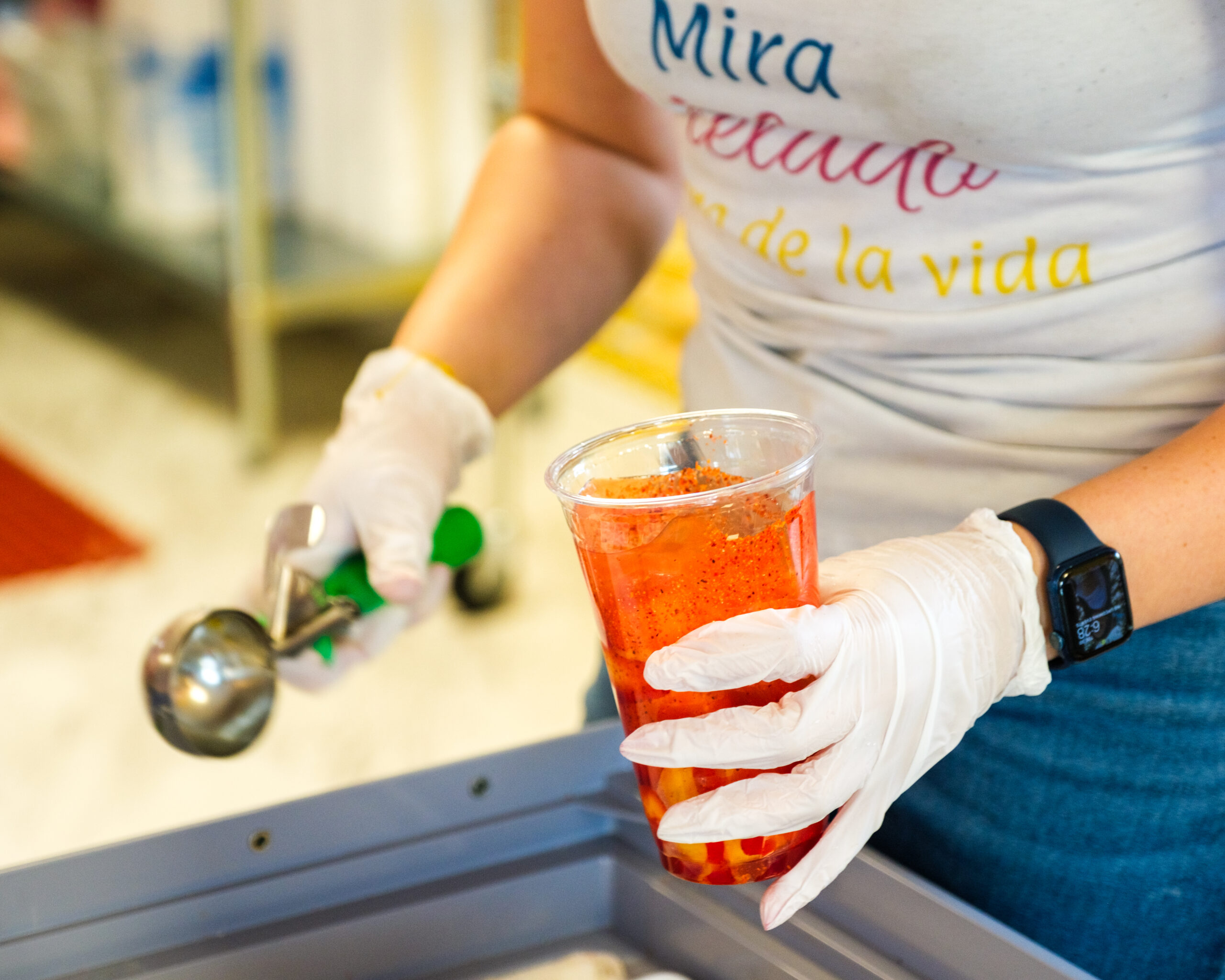 a person prepares a colorful drink