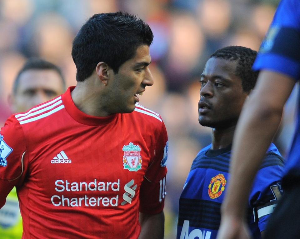 Luis Suarez exchanges words with Manchester United's French defender Patrice Evra (AFP via Getty Images)