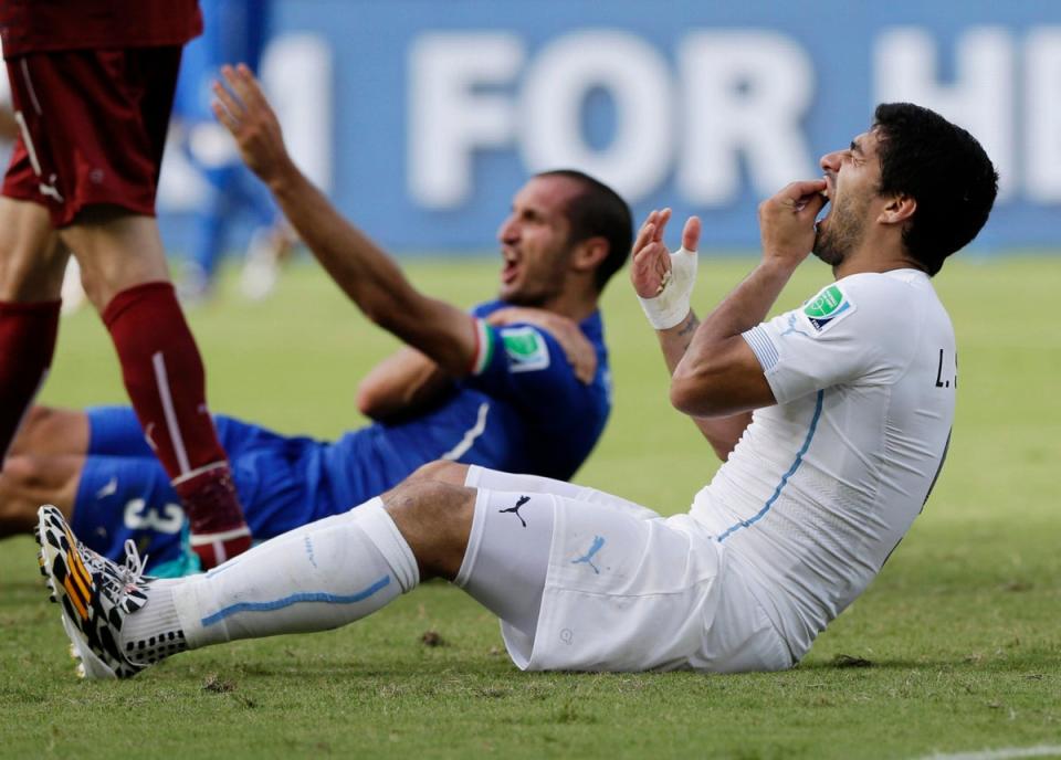 Suarez and Chiellini react to the incident (AP)