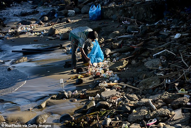 Indonesia produced the third highest level of plastic pollution. Due to a large population and poor refuse collection services. the nation created 3.4 million tonnes in 2020. Pictured: a person collecting plastic water bottles in Padang City