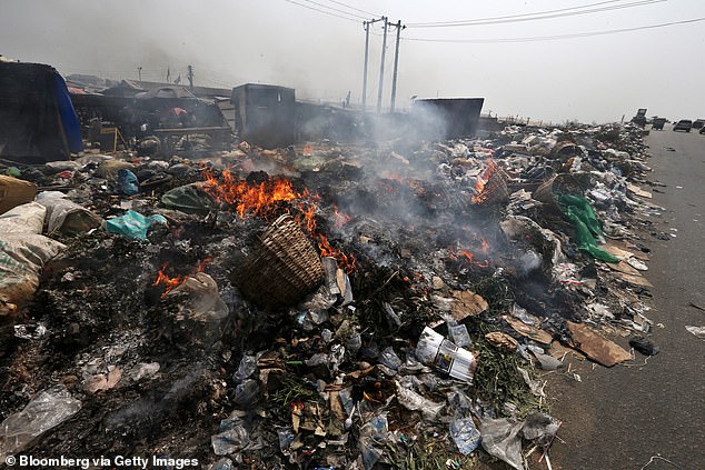 Nigeria produced the second most plastic waste, putting 3.5 million tonnes of waste into the environment each year. Pictured: burning waste in Yenagoa, Nigeria