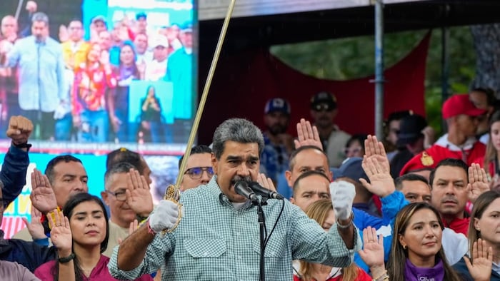 Venezuela's President Nicolás Maduro brandishes a sword as his new cabinet takes the oath of office at the presidential palace in Caracas, Venezuela on Wednesday, Aug. 28, 2024. 