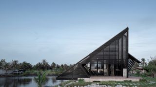 Touch Architect's backyard villa, a triangular house next to water