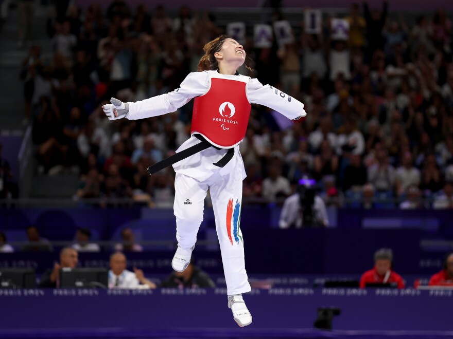 Taekwondo fighter Zakia Khudadadi of the Refugee Paralympic Team, originally from Afghanistan, celebrates after winning the women's contest on Aug.s 29.