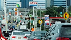 FILE PHOTO: People drive their cars near Exxon and BP gas stations at the exit of the Holland Tunnel during the start of the Memorial Day weekend, under rising gas prices and record inflation, in Newport, New Jersey, U.S., May 27, 2022.  REUTERS/Eduardo Munoz/File Photo