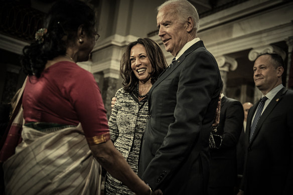 Harris, centre, talks with then-vice president Joe Biden and her aunt, Dr Sarala Gopalan, during her swearing-in ceremony in the Senate. Her husband, Doug Emhoff, is far right.