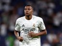 Real Madrid's Kylian Mbappe warms up for the Spanish La Liga soccer match between Real Madrid and Betis at the Santiago Bernabeu stadium in Madrid, Spain, Sunday, Sept. 1, 2024.