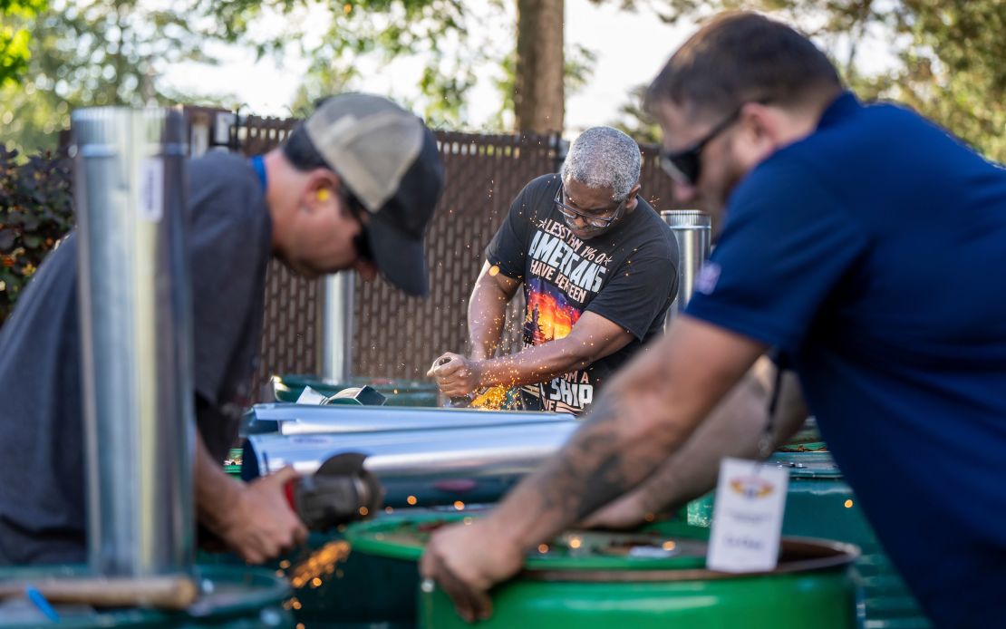 International Aerospace Machinists member Clint Moore, center, builds burn barrels with fellow union members in preparation for a strike if members reject a contract offer by airplane maker Boeing on September 12, 2024, in Seattle, Washington.