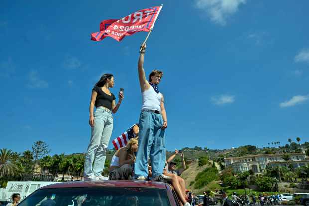 Hundreds of Donald Trump supporters line Trump National Road as...