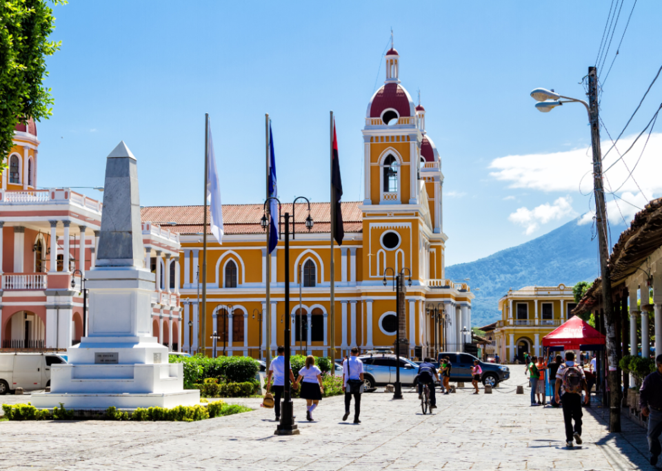 People walking by a Cathedral in Granada, Nicaragua