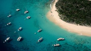 Yachts approaching an island in the British Virgin Islands