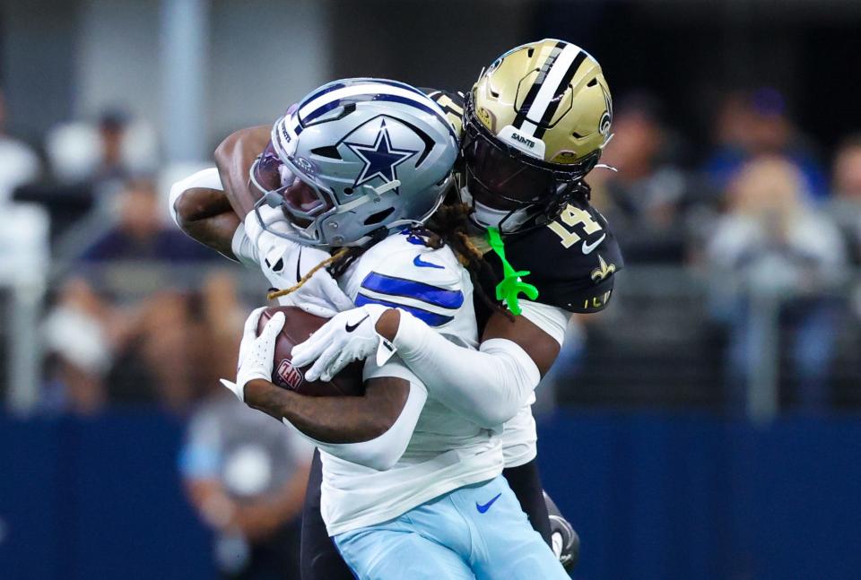 Sep 15, 2024; Arlington, Texas, USA; New Orleans Saints cornerback Kool-Aid McKinstry (14) tackles Dallas Cowboys wide receiver KaVontae Turpin (9) during the first quarter at AT&T Stadium. Mandatory Credit: Kevin Jairaj-Imagn Images