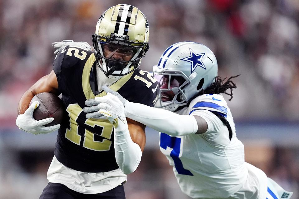 ARLINGTON, TEXAS - SEPTEMBER 15: Chris Olave #12 of the New Orleans Saints is tackled by Trevon Diggs #7 of the Dallas Cowboys during the first quarter at AT&T Stadium on September 15, 2024 in Arlington, Texas. (Photo by Sam Hodde/Getty Images)