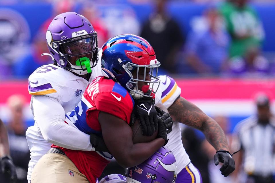 EAST RUTHERFORD, NEW JERSEY - SEPTEMBER 8: Dallas Turner #15 of the Minnesota Vikings tackles Devin Singletary #26 of the New York Giants at MetLife Stadium on September 8, 2024 in East Rutherford, New Jersey. (Photo by Mitchell Leff/Getty Images)