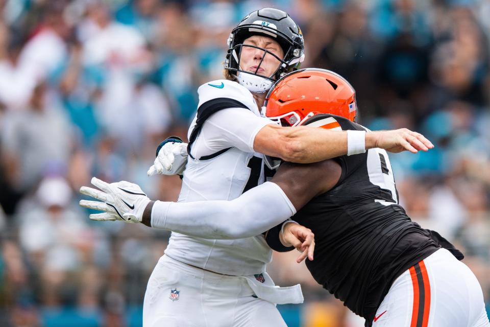 Sep 15, 2024; Jacksonville, Florida, USA; Cleveland Browns defensive tackle Dalvin Tomlinson (94) hits Jacksonville Jaguars quarterback Trevor Lawrence (16) as he throws in the fourth quarter at EverBank Stadium. Mandatory Credit: Jeremy Reper-Imagn Images