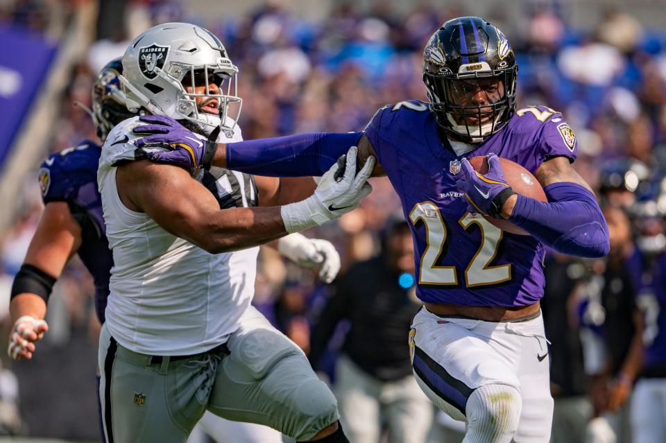 Sep 15, 2024; Baltimore, Maryland, USA; Baltimore Ravens running back Derrick Henry (22) stiff arms Las Vegas Raiders defensive tackle Christian Wilkins (94) during the second half at M&T Bank Stadium. Mandatory Credit: Tommy Gilligan-Imagn Images