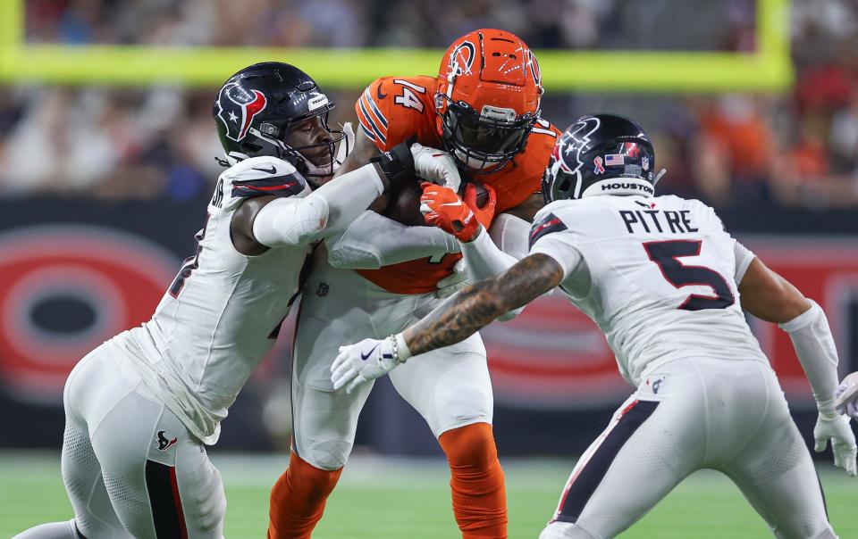 Sep 15, 2024; Houston, Texas, USA; Houston Texans defensive end Will Anderson Jr. (51) and safety Jalen Pitre (5) attempt to tackle Chicago Bears tight end Gerald Everett (14) during the second quarter at NRG Stadium. Mandatory Credit: Troy Taormina-Imagn Images