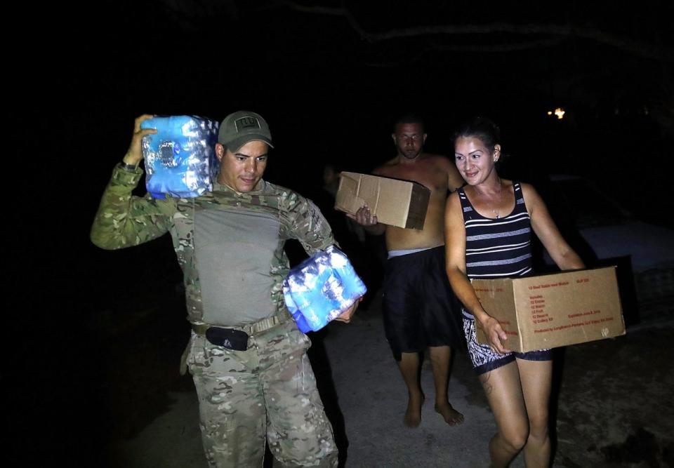 PHOTO: In this Oct. 4, 2017, file photo, U.S. Army 1st Special Forces Command SFC Charles Fernandez helps deliver food and water to people in the wake of the devastation left across the island by Hurricane Maria in Utuado, Puerto Rico. (Joe Raedle/Getty Images, FILE)