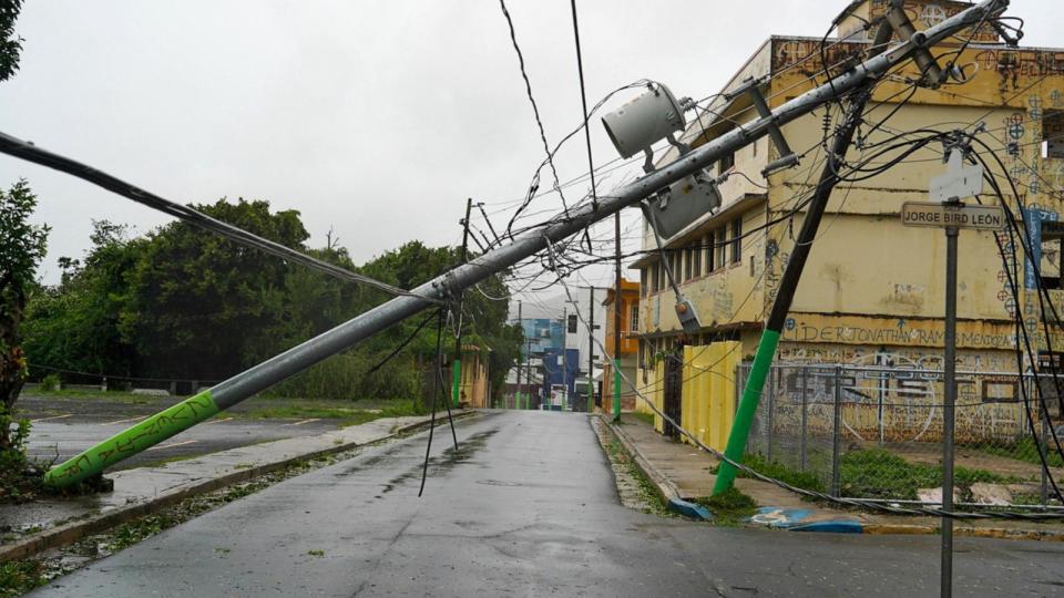 PHOTO: In this Aug. 14, 2024, file photo, broken electricity lines above homes damaged are seen after Tropical Storm Ernesto hit Fajardo, Puerto Rico. (Jaydee Lee Serrano/AFP via Getty Images, FILE)