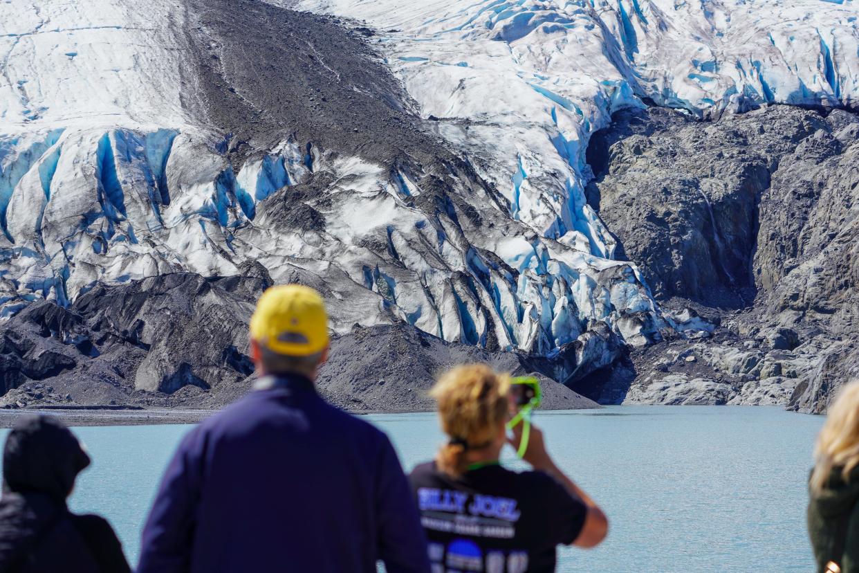 Tourists look at the melting Portage Glacier near Hope, Alaska, from aboard the M/V Ptarmigan.