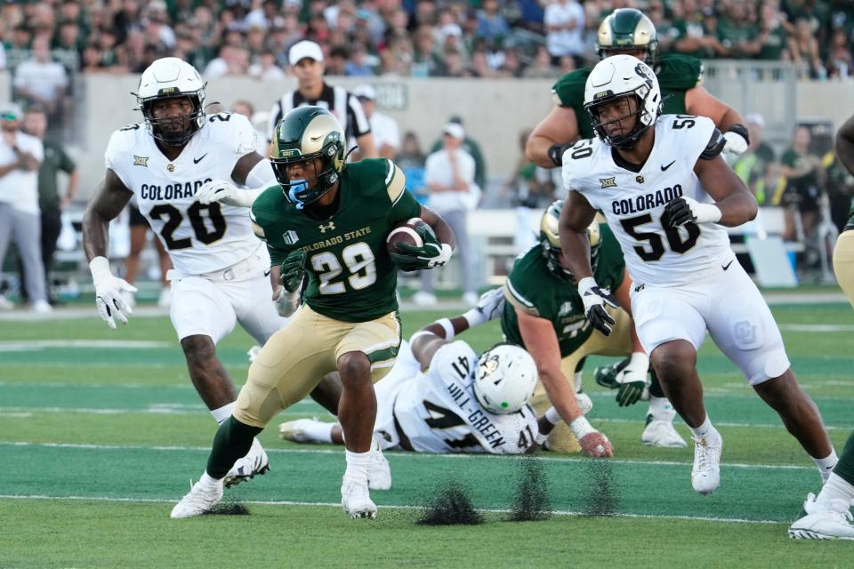 Sep 14, 2024; Fort Collins, Colorado, USA; Colorado State Rams running back Justin Marshall (29) finds a hole to run for positive yards at Sonny Lubick Field at Canvas Stadium. Mandatory Credit: Michael Madrid-Imagn Images