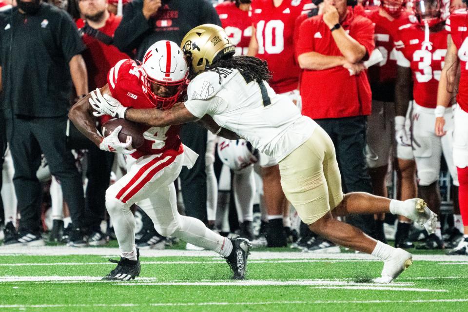 Sep 7, 2024; Lincoln, Nebraska, USA; Nebraska Cornhuskers wide receiver Jahmal Banks (4) is tackled by Colorado Buffaloes safety Cam'Ron Silmon-Craig (7) to end the third quarter at Memorial Stadium. Mandatory Credit: Dylan Widger-Imagn Images