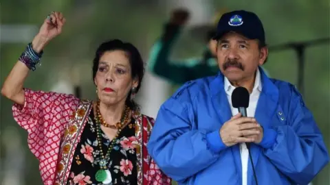 AFP Nicaraguan President Daniel Ortega (R) and his wife, Vice President Rosario Murillo, cheer at supporters during the government-called 