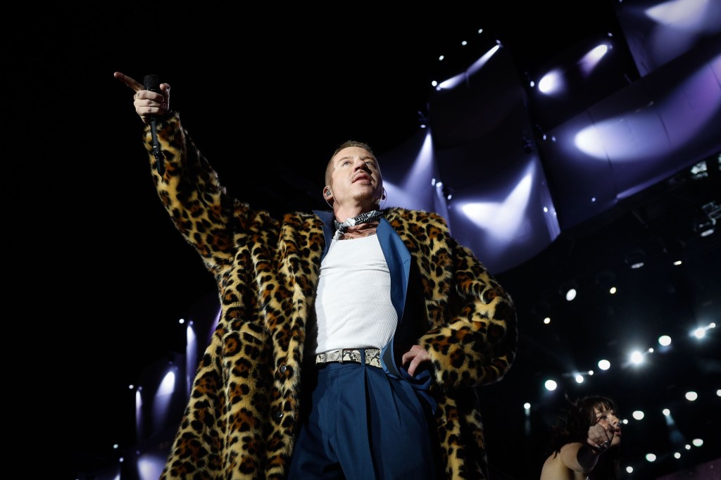 Macklemore in leopard print coat performing onstage at the Rock in Rio 2024 festival in Lisbon, Portugal