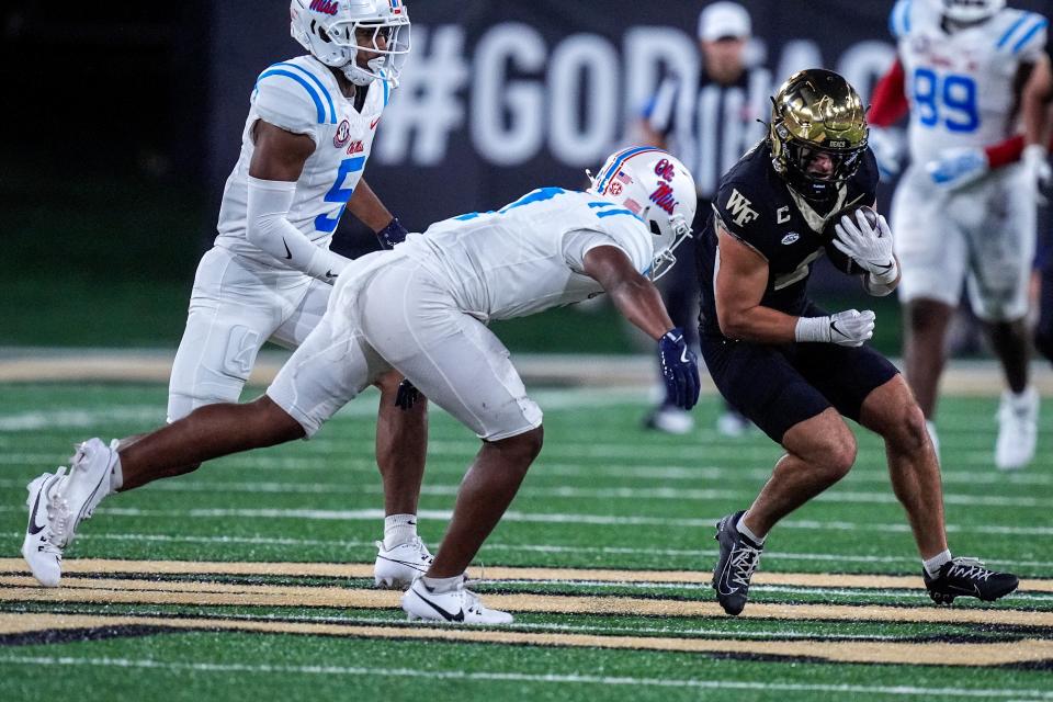 Sep 14, 2024; Winston-Salem, North Carolina, USA; Wake Forest Demon Deacons wide receiver Taylor Morin (2) tries to outrun Mississippi Rebels cornerback Brandon Turnage (8) during the first half at Allegacy Federal Credit Union Stadium. Mandatory Credit: Jim Dedmon-Imagn Images