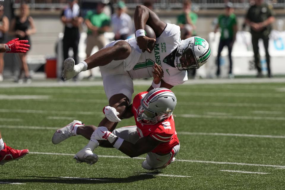 COLUMBUS, OHIO - SEPTEMBER 21: Safety Caleb Downs #2 of the Ohio State Buckeyes tackles Quarterback Braylon Braxton #1 of the Marshall Thundering Herd as he carries the ball during the third quarter at Ohio Stadium on September 21, 2024 in Columbus, Ohio. (Photo by Jason Mowry/Getty Images)