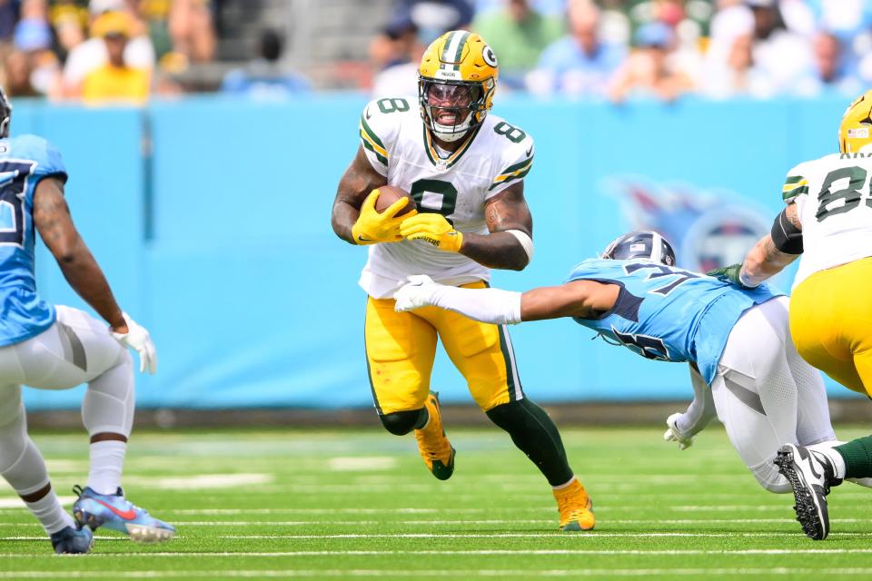 Sep 22, 2024; Nashville, Tennessee, USA; Green Bay Packers running back Josh Jacobs (8) breaks the tackle of Tennessee Titans cornerback L'Jarius Sneed (38) during the first half at Nissan Stadium. Mandatory Credit: Steve Roberts-Imagn Images