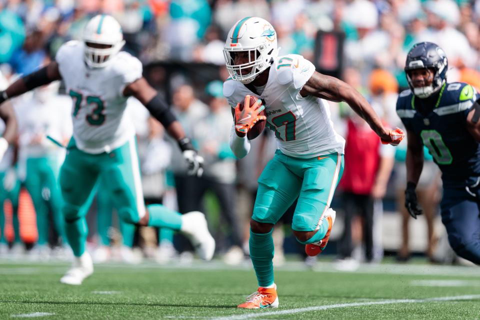 Sep 22, 2024; Seattle, Washington, USA; Miami Dolphins wide receiver Jaylen Waddle (17) runs with the ball during the second quarter against Seattle Seahawks at Lumen Field. Mandatory Credit: Kevin Ng-Imagn Images