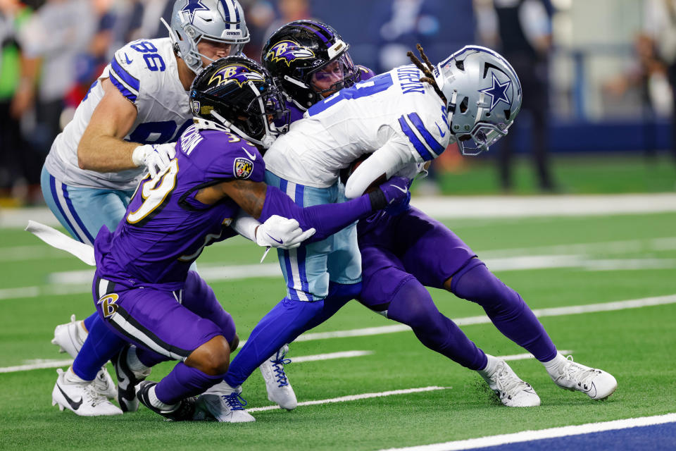 Sep 22, 2024; Arlington, Texas, USA; Dallas Cowboys wide receiver KaVontae Turpin (9) is tackled shot of the goal line by Baltimore Ravens safety Eddie Jackson (39) and safety Marcus Williams (32) during the fourth quarter against the Baltimore Ravens at AT&T Stadium. Mandatory Credit: Andrew Dieb-Imagn Images