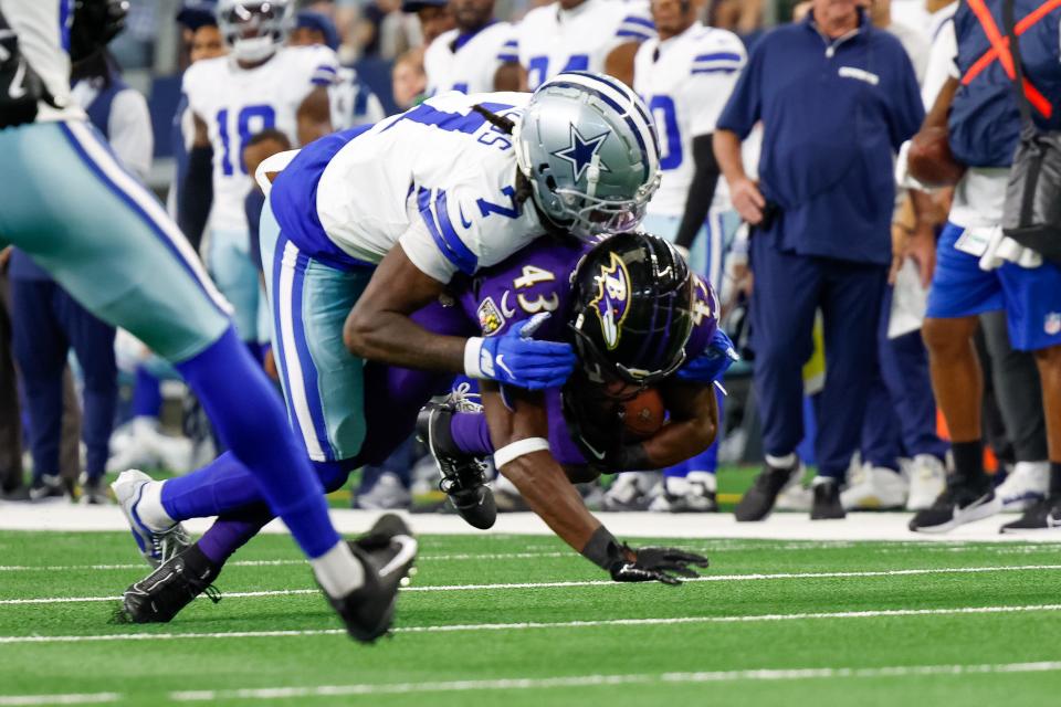 Sep 22, 2024; Arlington, Texas, USA; Baltimore Ravens running back Justice Hill (43) is tackled by Dallas Cowboys cornerback Trevon Diggs (7) during the second quarter at AT&T Stadium. Mandatory Credit: Andrew Dieb-Imagn Images