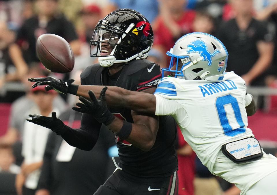 Arizona Cardinals receiver Marvin Harrison Jr. (18) tries to catch the ball as Detroit Lions cornerback Terrion Arnold (0) deflects it away at State Farm Stadium in Glendale, Ariz., Sep 22, 2024.