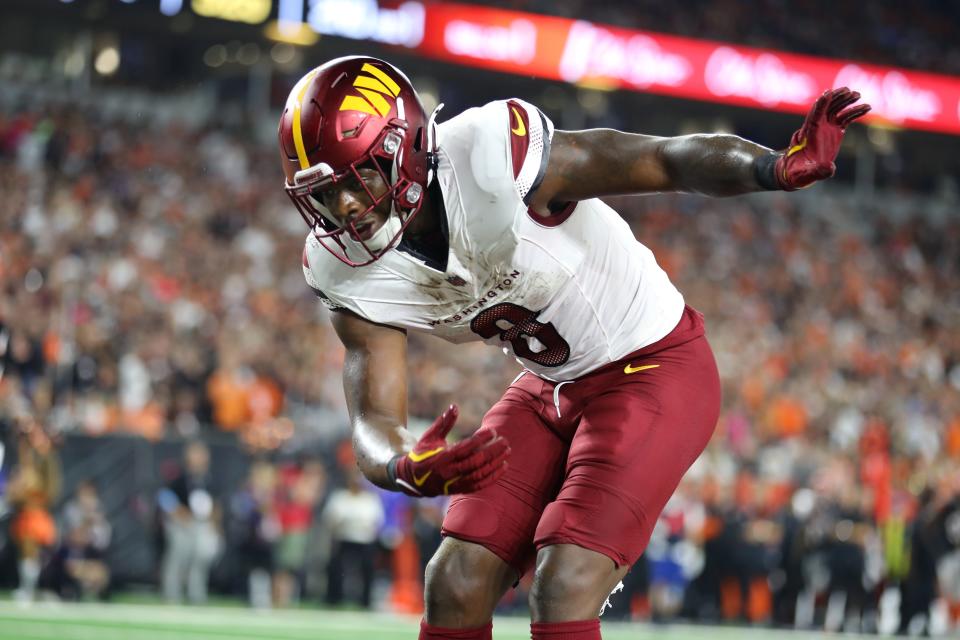 Sep 23, 2024; Cincinnati, Ohio, USA; Washington Commanders running back Brian Robinson Jr. (8) celebrates a touchdown during the first quarter against the Cincinnati Bengals at Paycor Stadium. Mandatory Credit: Joseph Maiorana-Imagn Images