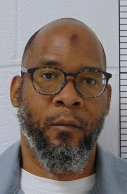 Booking photo of Marcellus Williams who was convicted in the 1998 murder of a former St. Louis Post-Dispatch police reporter show shim wearing glasses and a gray blouse over a white shirt