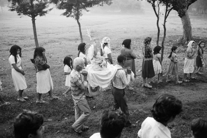 An altar with a statue of Jesus Christ is carried in a religious procession through the streets in Perquín, Morazán department, El Salvador, October 23, 1983.