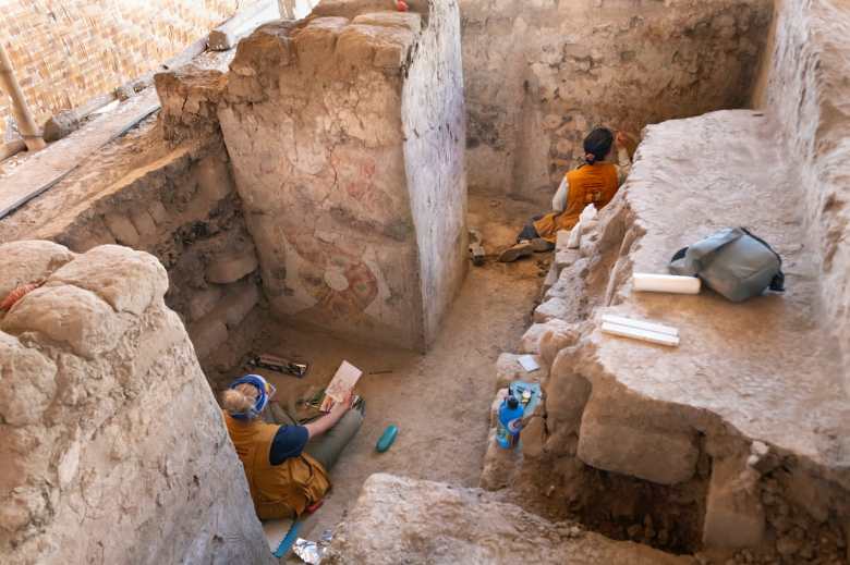 Archaeologists Michele Koons and Lisa Trever study the painted architecture of the Hall of the Braided Serpents