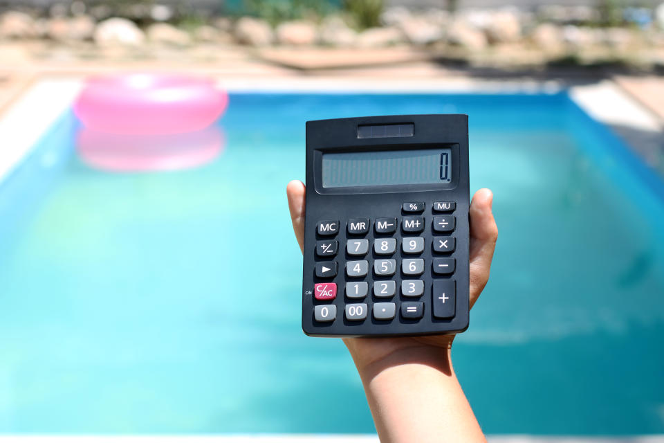 Calculator on hand with the swimming pool,