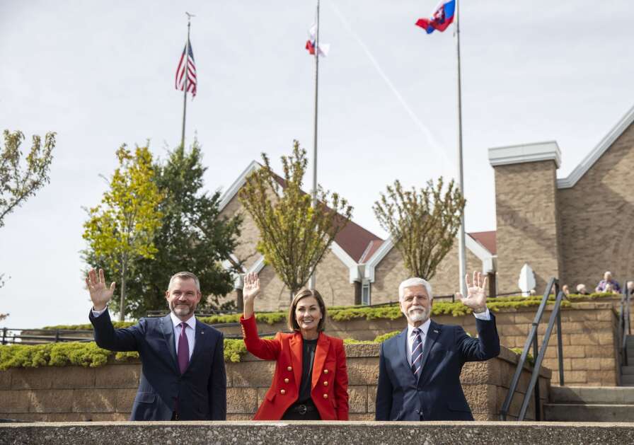 Slovak Republic President Peter Pellegrini, from left, Iowa Gov. Kim Reynolds, and Czech Republic President Petr Pavel gather on the terrace of the National Czech and Slovak Museum and Library to recreate the photo of the previous presidents in 1995 in Cedar Rapids on Friday. (Savannah Blake/The Gazette)