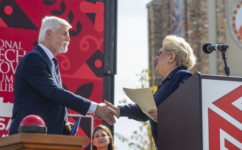 Czech Republic President Petr Pavel shakes hands with National Czech and Slovak Museum and Library President and CEO Cecilia Rokusek during the dedication of the Buresh Immigration Clock Tower in Czech Village in Cedar Rapids on Friday. (Savannah Blake/The Gazette)