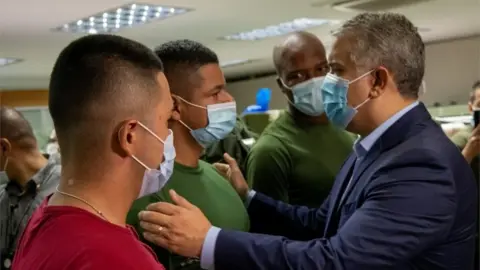 Reuters Colombia's President Ivan Duque greets police officers at the Metropolitan Police Command in Cali, Colombia, May 28, 2021.