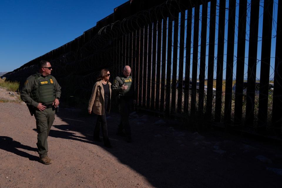 Democratic presidential nominee Vice President Kamala Harris talks with John Modlin, the chief patrol agent for the Tucson Sector of the U.S. Border Patrol, right, and Blaine Bennett, the U.S. Border Patrol Douglas Station border patrol agent in charge, as she visits the U.S. border with Mexico in Douglas, Arizona, on Friday (AP)