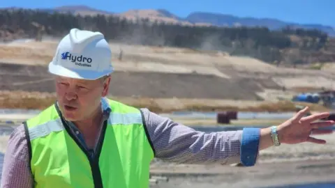 Wayne Preece in hard hat and high-viz jacket at his new plant in Ecuador