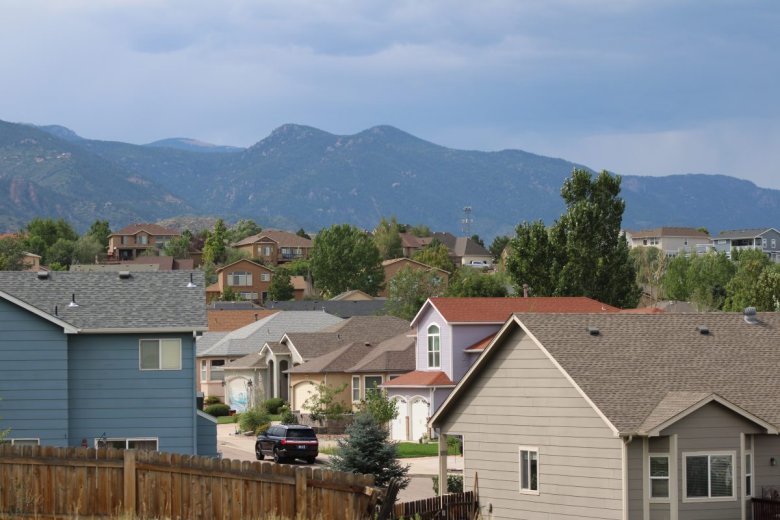 Suburban rooftops with the foothills west of Colorado Springs as a backdrop.